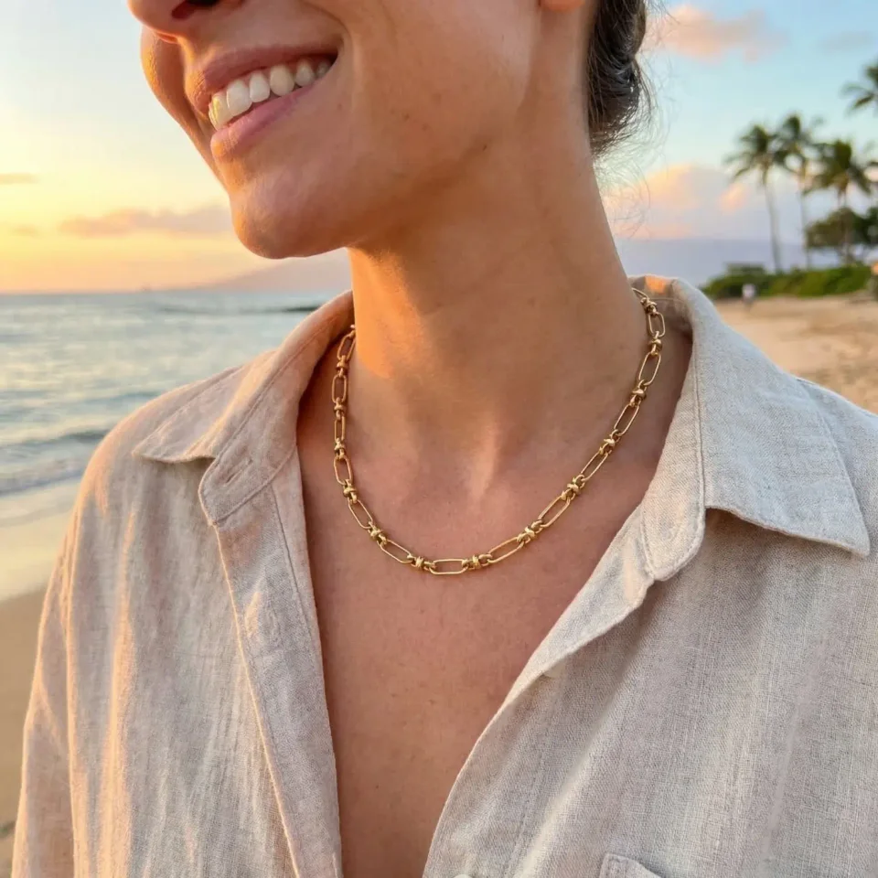 Jewelry lifestyle image: gold chain necklace sunset