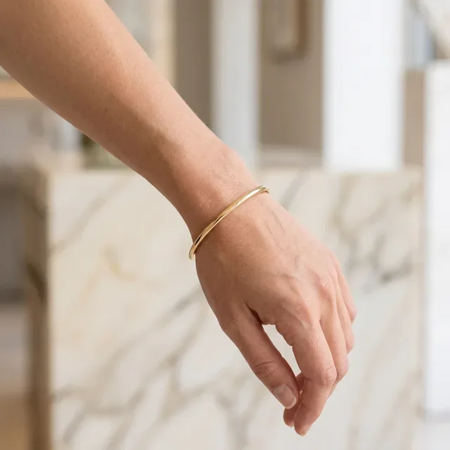 Preview image of the Bangle Bracelets preset: A bracelet on the wrist, in a bright room with marble.