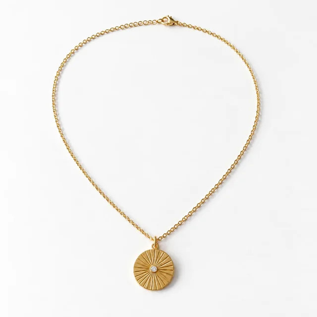 Generated image: the gold medallion necklace with the Clean White Catalog preset