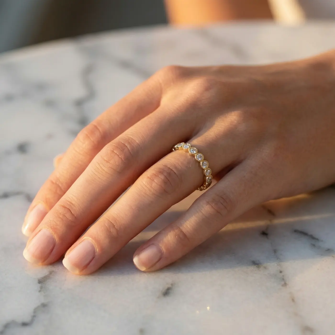 Jewelry lifestyle image: diamond band marble hand